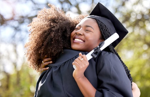 students graduating hugging iStock-1373670716