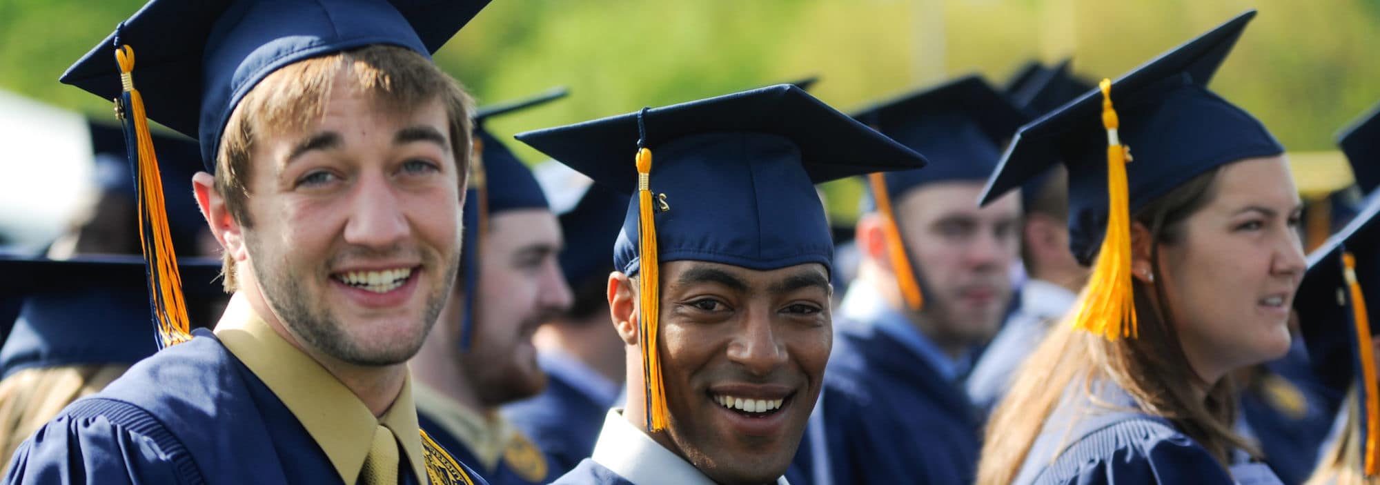 graduates in a row in caps and gowns